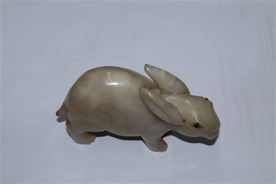 A 19th century Chinese white jade figure of a rabbit, glass inset eyes